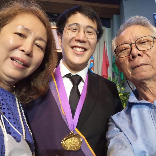 Gilbert with his parents after graduating with an MS in Data Science degree.